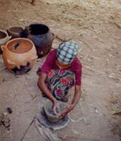 a West Wallaga potter shaping a vessel