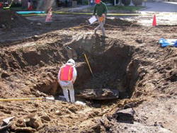 A worker from Independent Archeological Consultants, LLC, assists in the first or eight burials removed from Chestnut Street, photo by PBHTrail