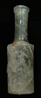 Figure9. The rare Tabasco bottle recovered during archaeological excavations of the Boston Saloon is shown here, with acloseupviewof thebasemark. Photos by RonaldM. James.