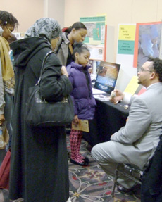 Cheyney University Internship student Tristan Hebron talking with members of the public about African American archaeology at the 7th annual Black History Showcase at the Philadelphia Convention Center, Photo by P. L Jeppson.