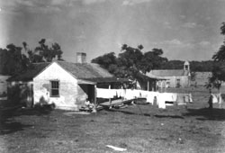 1926 photograph of two remaining brick houses and wooden church once standing in southeast area of the site, image by Robert Tebbs, Louisiana State Museum Collection